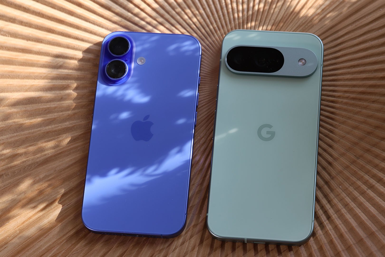 Side-by-shot shot of iPhone 16 and Pixel 9 face-down