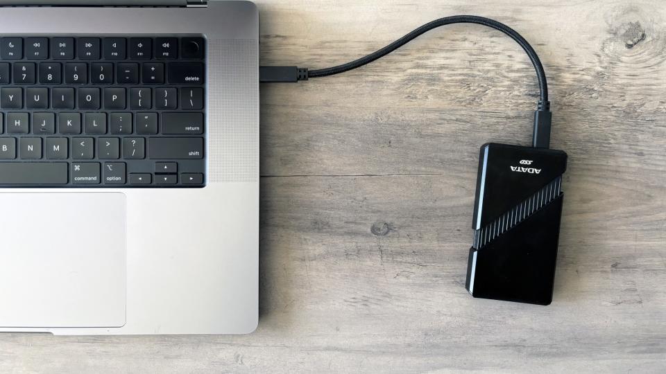 The ADATA SE920 portable SSD connected to an Apple MacBook Pro.