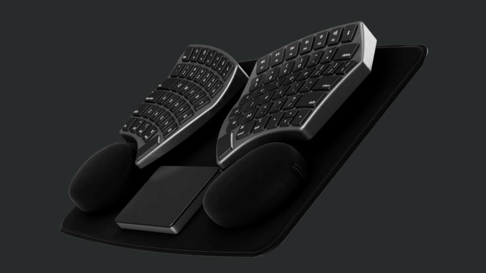 Angle view of the Nuio split keyboard with trackpad, wristpads and deskpad.