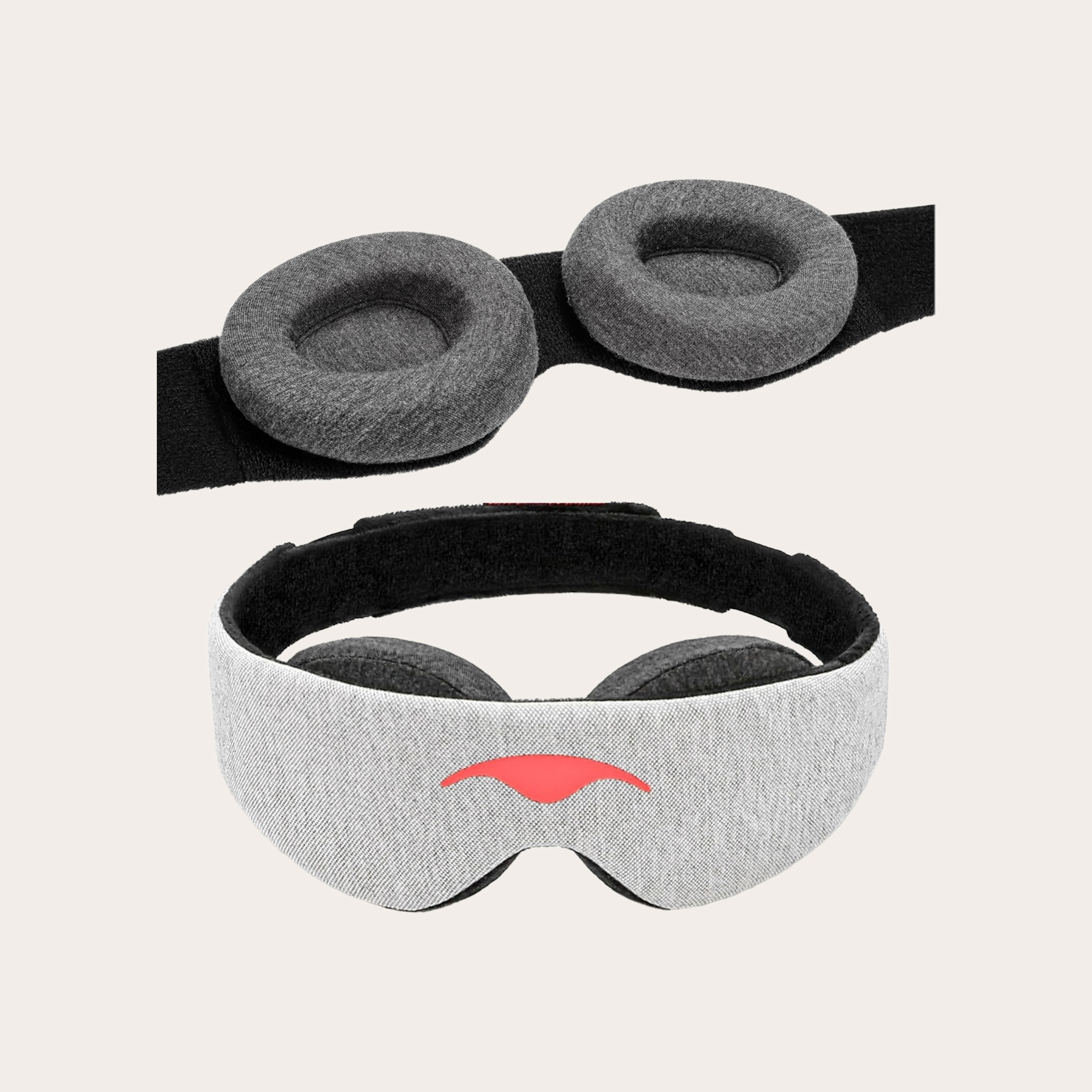 Light grey sleep mask placed on tan background.