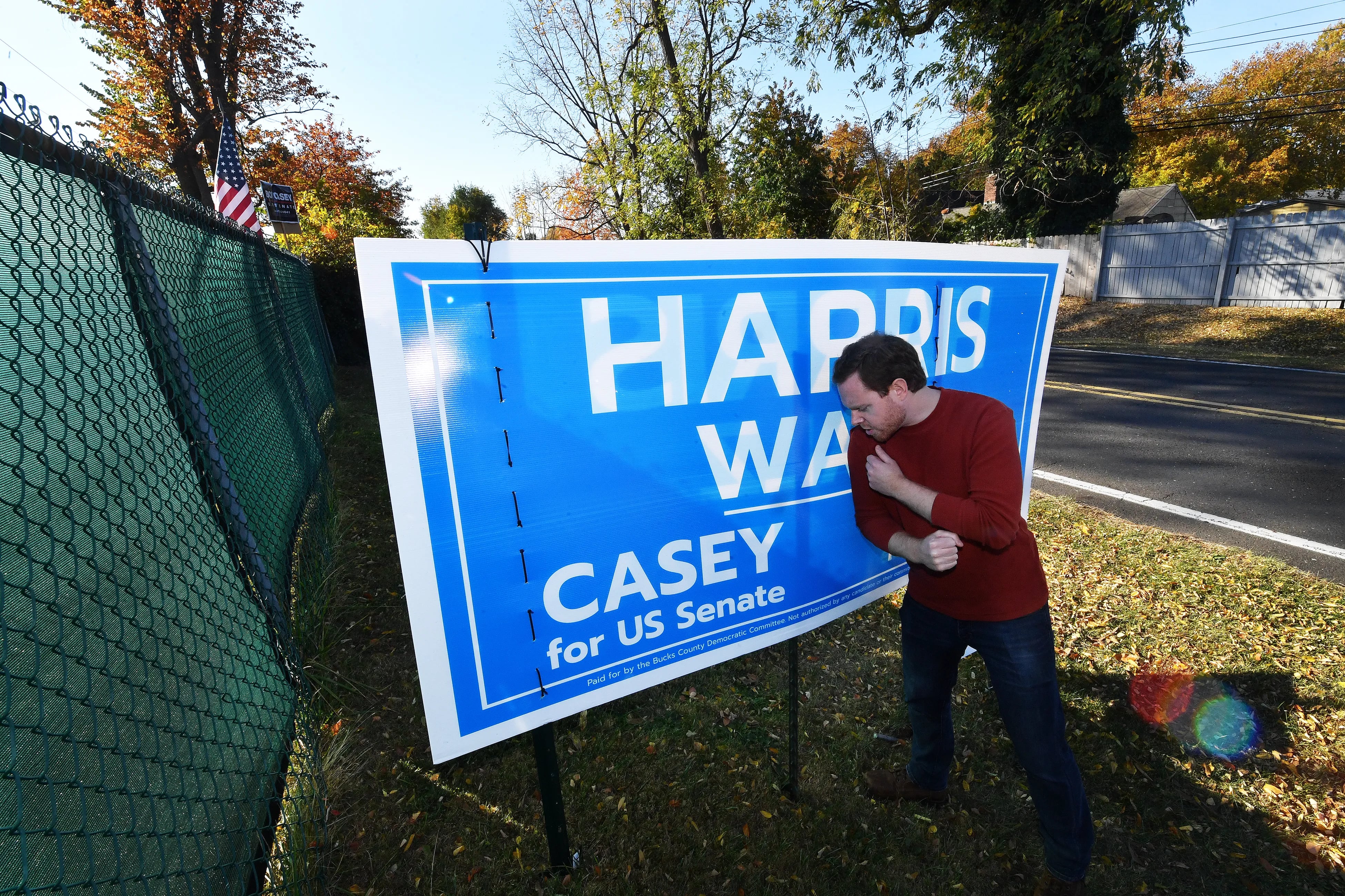 Nicholas McGoldrick, of Levittown, Pa., demonstrates how his Harris-Walz sign was vandalized. McGoldrick filed two police reports after his signs were vandalized in Aug. and Sept. 2024.