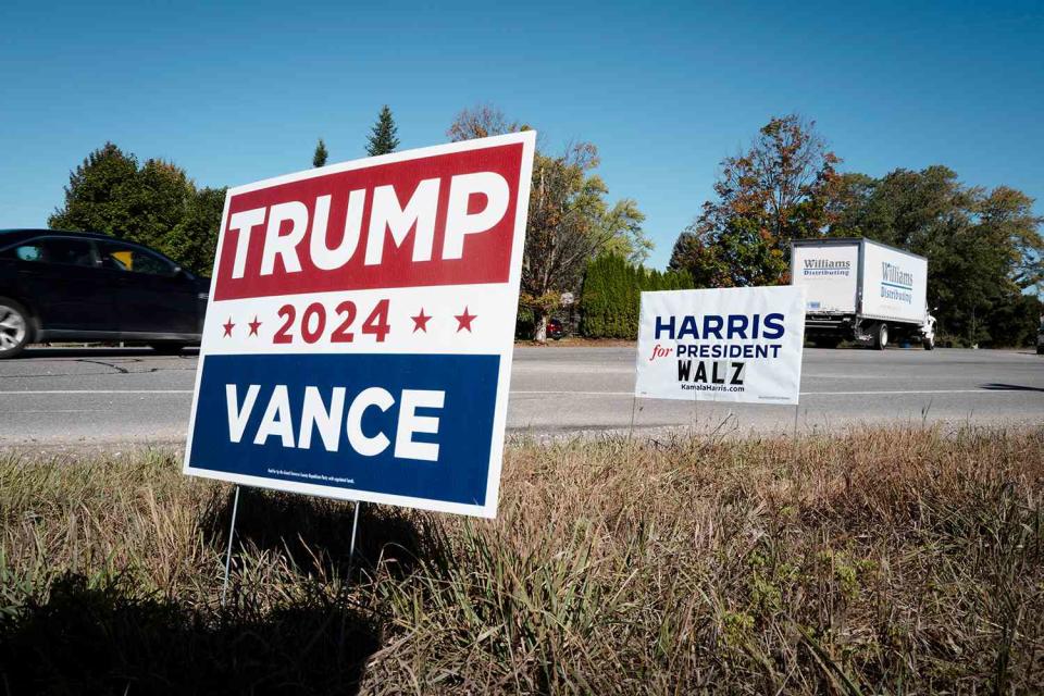 <p>Scott Olson/Getty</p> Two political signs showing support for the Vice President Kamala Harris and Former President Donald Trump near Traverse City, Michigan. 