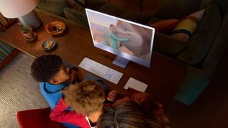 A family watching a video on an iMac M4 desktop PC